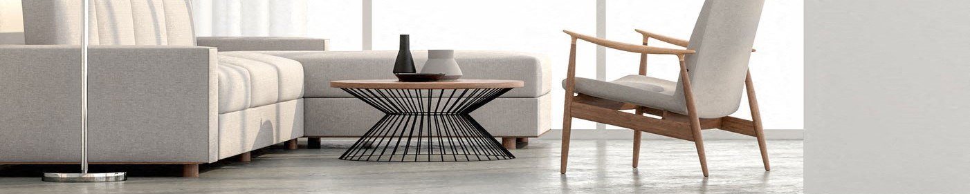 A modern living room with a grey sofa, a wooden chair, and a black and white table.